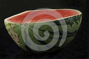Half watermelon isolated on black background photo