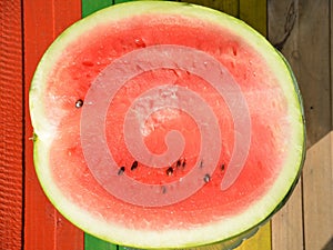 Half watermelon on a multi-colored background