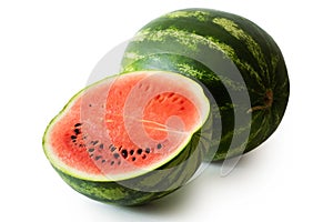 Half watermelon with seeds next to whole watermelon isolated on