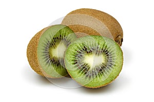 Half and whole kiwis isolated on white background