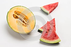 Half a yellow melon. Pieces of chopped watermelon