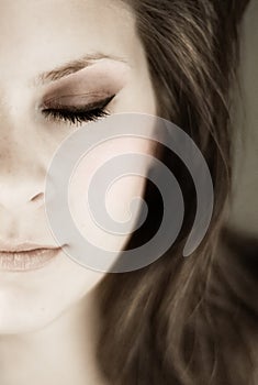 Half young womans face with eyes closed