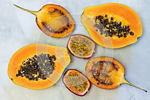 Halfs of tropical fruits papaya, tamarillo, passion fruit