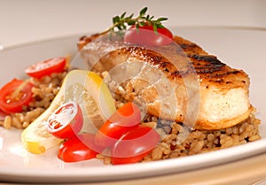 Halibut seared on a bed of brown rice photo