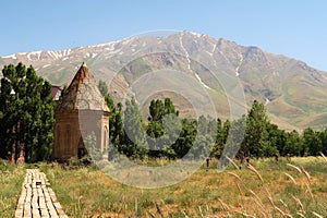 The Halime Hatun tomb, grave, mausoleum, Halime Hatun Kümbeti with the snow covered Mount Artos in the background, close to Lake
