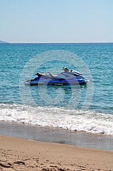 Blue sea and a jet ski floating on Aegean sea.