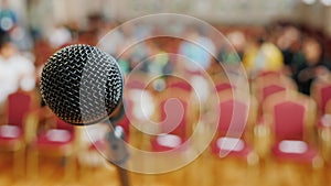 Hall for the conference, in the foreground the rack with a microphone.