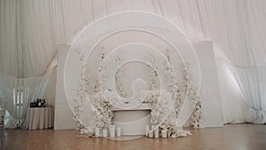 Hall decor with a white table decorated with flowers