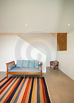 Hall with divan and striped rug