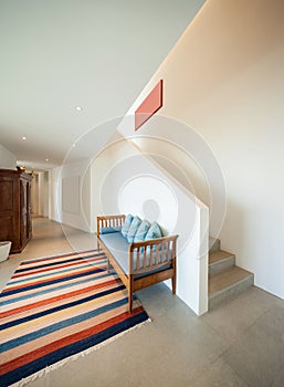 Hall with divan and striped rug photo