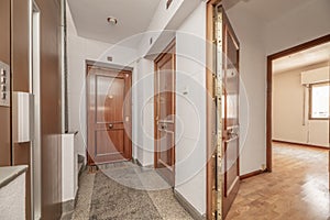Hall of a house with armored door, elevator and terrazzo floors