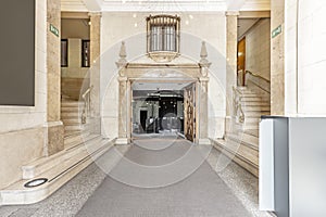 Hall of a mansion with stairs and decorative materials of marble and granite floors with elongated carpet