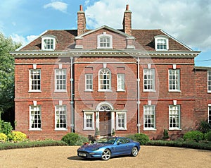 The Hall, Much Hadham, with an Aston Martin DB7 parked in the driveway. Hertfordshire. UK