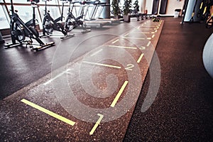 Hall with sports inventory and equipment in an empty fitness center.