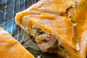 A hallaca split in two. On banana leaves and cooked served in December photo