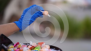 Halloween 2020: close-up of a gloved hand giving out candy to a young girl in a costume