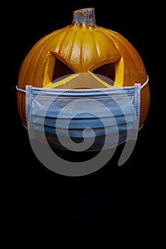 halloween in the age of coronavirus - pumpkin with face mask