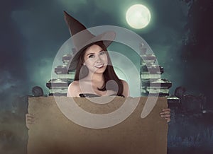 Halloween asian witch with hat holding blank paper