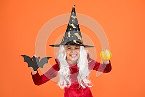 Halloween attributes. Little child in witch costume. Magical spell. Small witch with white hair. Wizard or magician