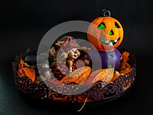 halloween autumn decoration with cute little dwarf and illuminated pumpkin head orange colors on black background