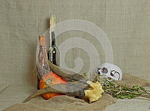 Halloween autumn still life. Pumpkin, candles in bottles, horns. Black magic. Light canvas background