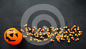 Halloween Background Candy corn candies, pumpkin basket. Traditional sweet Treats. Copy space