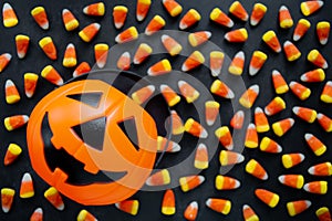 Halloween Background Candy corn candies, pumpkin basket. Traditional sweet Treats. Copy space