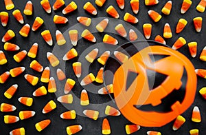 Halloween Background. Candy corn candies, pumpkin basket. Traditional sweet Treats. Copy space