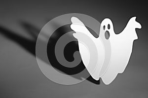 Halloween background concept. Funny ghost doing boo gesture and