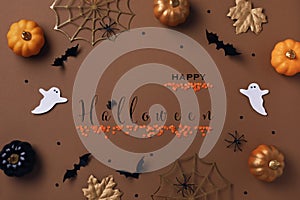 Halloween background with decorations from pumpkins, bats, spider web and ghosts. Holiday greeting card with text Happy halloween