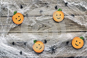 Halloween background with decorative pumpkins, creepy web and sp