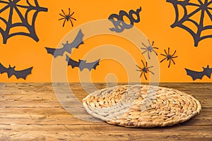 Halloween background with empty wooden table and wicker round placemat