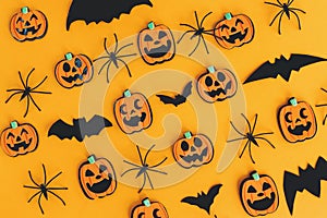Halloween background. Modern pumpkins jack o lantern, spiders, bats layout on orange background. Happy Halloween flat lay.