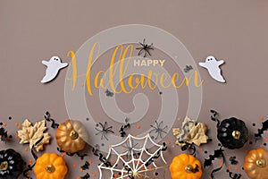 Halloween background with decorations from pumpkins, bats, spider web and ghosts top view. Holiday greeting card Happy halloween