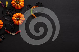 Halloween background with pumpkins, candy, decorations. Halloween party invitation card mockup. Flat lay, top view, copy space