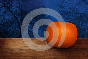 Halloween banner with pumpkin on wood, blue night