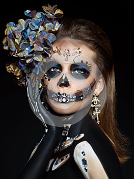 Halloween beauty portrait of a skeleton woman of death, the makeup on the face. Girl death Halloween costume. Day of The Dead.