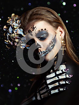 Halloween beauty skeleton woman makeup face Bokeh glitter. Girl death Halloween costume. Day of The Dead. Charming and dangerous