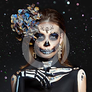 Halloween beauty skeleton woman makeup face Bokeh glitter. Girl death Halloween costume. Day of The Dead. Charming and dangerous