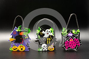 Halloween Candy Bags Cute Felt Pouches with Handles, Trick or Treat Goody Bags on black background