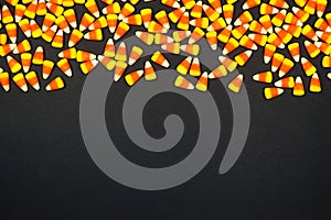 Halloween candy corn top border on a black background