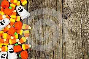 Halloween candy side border against rustic wood