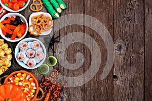 Halloween candy buffet side border over a rustic wood background