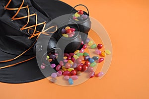 Halloween candy in trick or treat carry cauldrons with witches hat