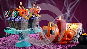 Halloween candyland drip cake style cupcakes in party table setting.