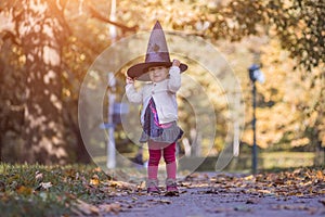 HALLOWEEN CELEBRATION CARD. Cute toddler girl in black witch hat