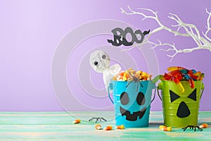 Halloween celebration concept with candy corn and candy in jack o lantern bucket for trick and treat