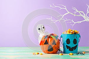 Halloween celebration concept with candy corn and candy in jack o lantern bucket for trick and treat