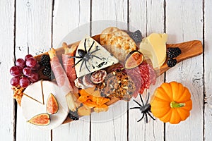 Halloween charcuterie board against a white wood background