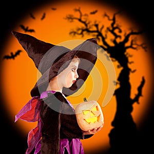 Halloween children girl holding pumpkin